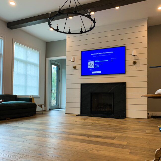 Television mounted cleanly over a fireplace with no visible cables, Houston install