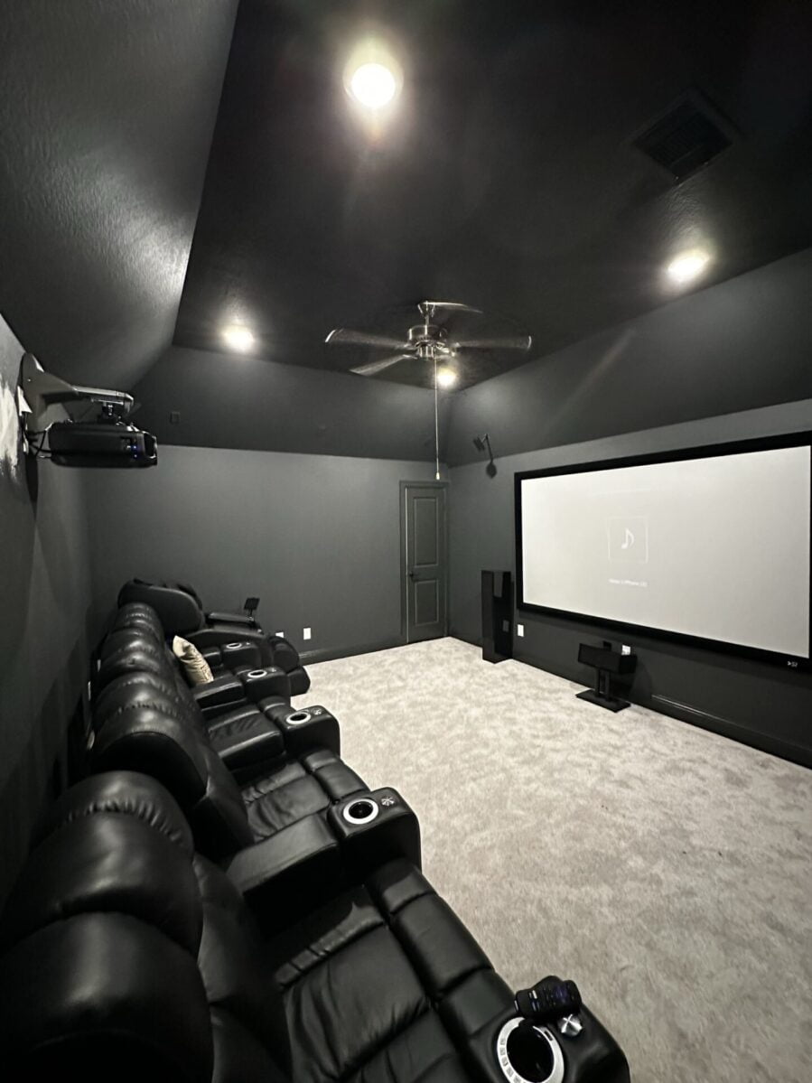 Large flat-panel TV mounted over a console with cables hidden, Houston home